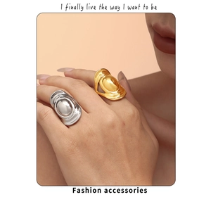 Artistic gold and silver wide liquid style oval rings shown on a model's hand