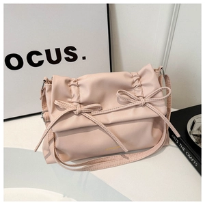 Detail of soft leather shoulder bag with double bow decoration and pleated design