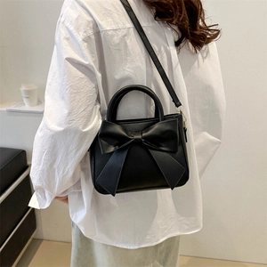 Minimalist black bow handbag with adjustable crossbody strap for women in 2024 fashion