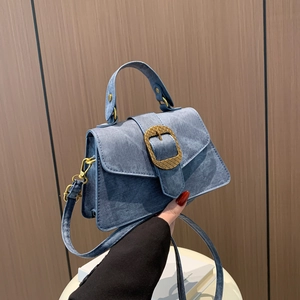Retro denim blue trapezoid handbag with a large vintage gold buckle and shoulder strap