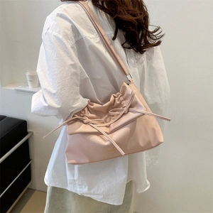 Chic pink soft faux leather tote bag with bow details and drawstring closure