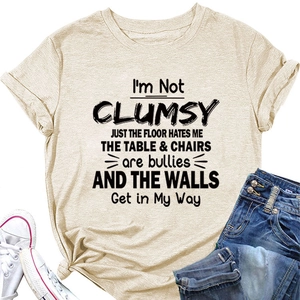 Detail of beige cotton t-shirt with slogan print, styled with jeans and white canvas shoes