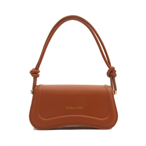 Elegant caramel brown leather hobo bag with a curved base and shoulder strap knot detail