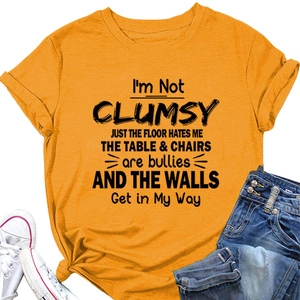 Detail of ginger yellow t-shirt with I'M NOT CLUMSY print styled with casual wear