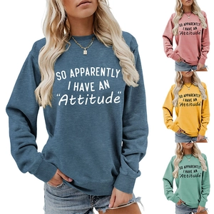 Close-up of crewneck sweatshirts showing various colors and 'Attitude' slogan print