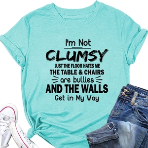Flat lay of cotton t-shirt with slogan styled with denim shorts and white sneakers