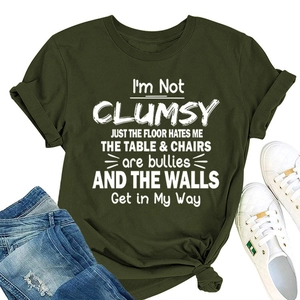 Detail of soft olive green cotton T-shirt featuring humor quote with denim shorts