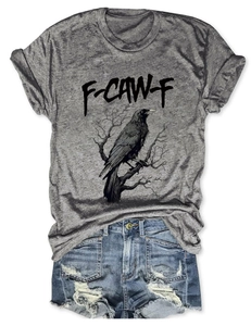 Flat lay of gray t-shirt with eagle print tucked into ripped denim shorts for summer
