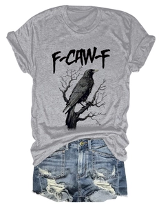 Close-up of a light grey t-shirt with a vintage eagle print and distressed denim shorts