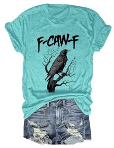 Detail of mint green T-shirt with crow print and distressed blue denim shorts