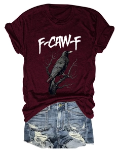 Close-up of maroon t-shirt featuring eagle graphic print and ripped denim shorts
