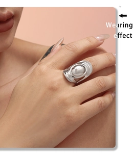 Close-up of polished silver liquid metal ring with dome detail on model's finger