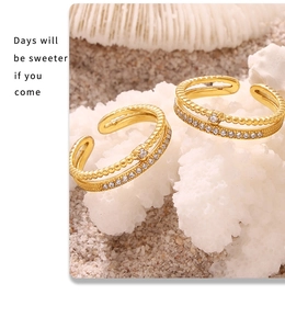 Detail of 18k gold plated double layer ring with sparkling zircon and beaded texture