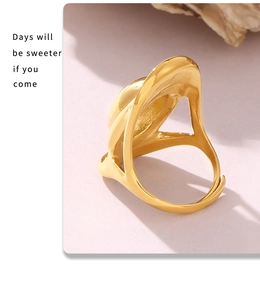 Detailed view of gold-plated oval cutout ring with unique wavy hollow design texture