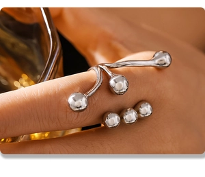 Close-up of modern silver branching ring with spherical beads on woman's hand