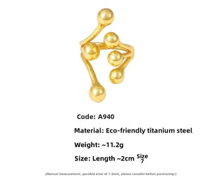 Detail view of 18K gold plated titanium steel branch ring with polished metal spheres