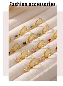 Detail view of colorful star-shaped glass pendants on 18K gold-plated stainless steel earrings