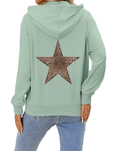 Detail of mint green hoodie back featuring a large leopard print star and ribbed cuffs