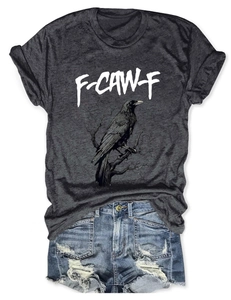 Close-up of eagle print charcoal t-shirt paired with distressed light blue denim shorts