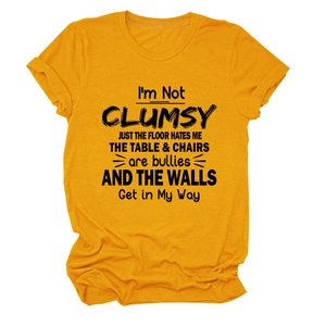 Close-up of ginger yellow cotton T-shirt with black slogan print and crew neck detail
