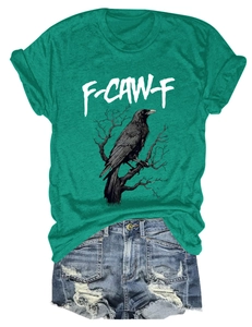 Detail of green t-shirt with crow graphic and distressed denim shorts set