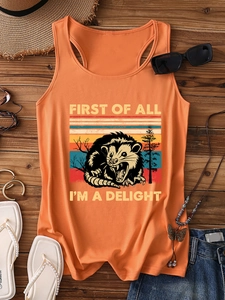 Flat lay of an orange possum tank top with sunglasses and summer travel accessories