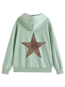 Detail of mint green hoodie featuring a leopard print star on the back with ribbed cuffs