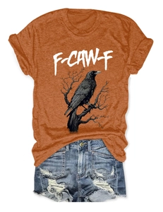 Flat lay of burnt orange eagle print T-shirt and distressed denim shorts street style outfit