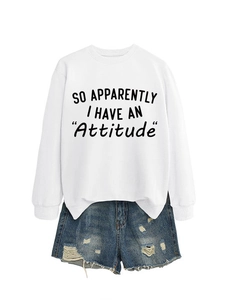 Close-up of white crewneck sweatshirt with slogan and distressed denim shorts set