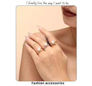 Detailed view of layered pearl rings with crystal accents on a model hand