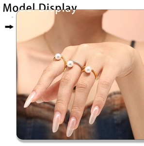 Close-up of model wearing three micro-pave zircon pearl rings in gold and silver finish