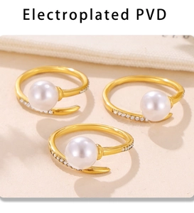 Detail of three gold plated open rings featuring large white pearls and pave crystals