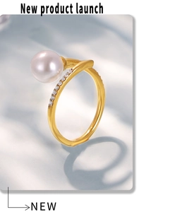 Detailed view of an elegant gold-plated open ring with a large pearl and micro-pave zircons