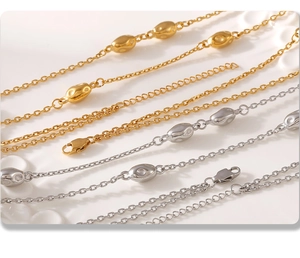 Close-up of double-layer stainless steel sweater necklace with polished metal beads