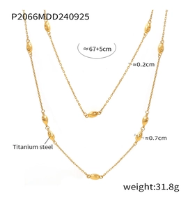 Detailed view of long gold titanium steel necklace with elegant smooth bean beads