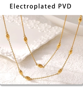Detailed macro view of long 18K gold plated double necklace with PVD coating beads