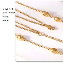 Detail of gold double-layer chain with irregular bean beads and lobster clasp closure