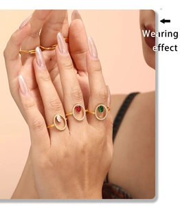 Detail view of gold-plated rings set with emerald, ruby, and clear zirconia stones