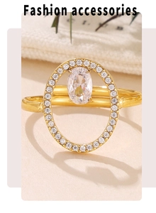 Macro detail of geometric gold ring with pavé crystals and oval center stone