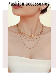Close-up of layered gold necklaces with lapis lazuli beads and matching gemstone earrings