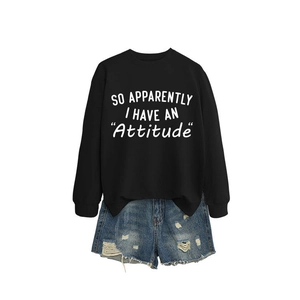 Women's black crewneck sweatshirt with 'Attitude' print and ripped denim shorts outfit