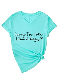 Detail of V-neck mint green T-shirt with 'Sorry I'm Late I Saw A Dog' text and knot hem