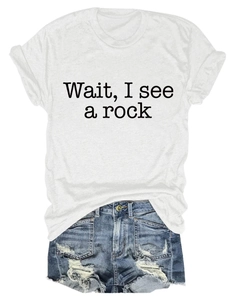 Detail of white cotton T-shirt featuring 'Wait, I see a rock' print and denim shorts