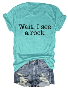 Detail of teal short sleeve T-shirt with graphic text and distressed denim shorts