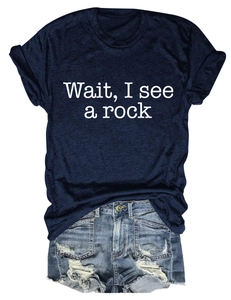 Detail of navy blue crew neck T-shirt with 'Wait, I see a rock' print and denim shorts