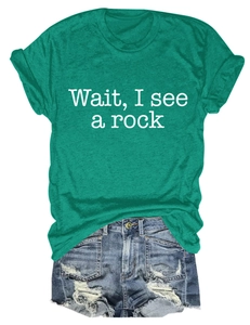 Detail view of teal t-shirt with Wait I See A Rock text and frayed denim shorts