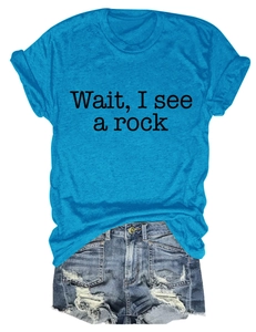 Detail view of the 'Wait I see a rock' slogan print on a bright blue cotton t-shirt