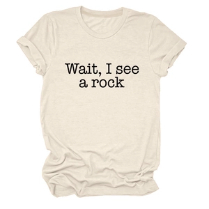 Detail of rolled sleeves and black serif text print on a beige crew neck t-shirt