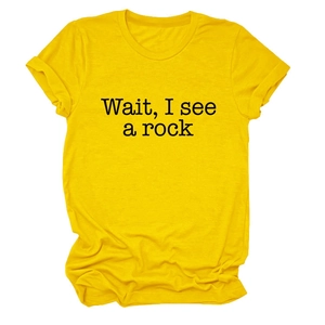Detailed view of yellow cotton t-shirt featuring the text Wait I See A Rock in black print