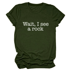Detailed flat lay of dark green T-shirt featuring Wait I see a rock white printed text
